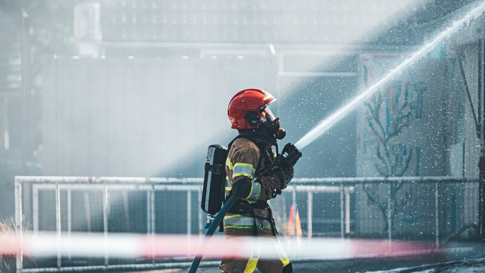 Photo of a Fireman Holding a Fire Hose